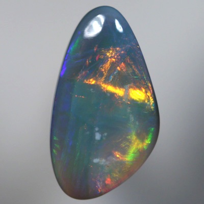 SOLID SEMI BLACK OPAL Large rolling flashes of reds, oranges over blue, purple